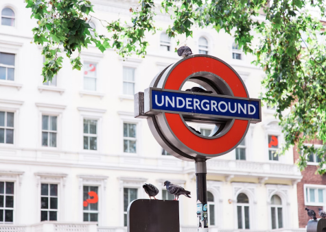 Image of a London underground sign in front of a building.