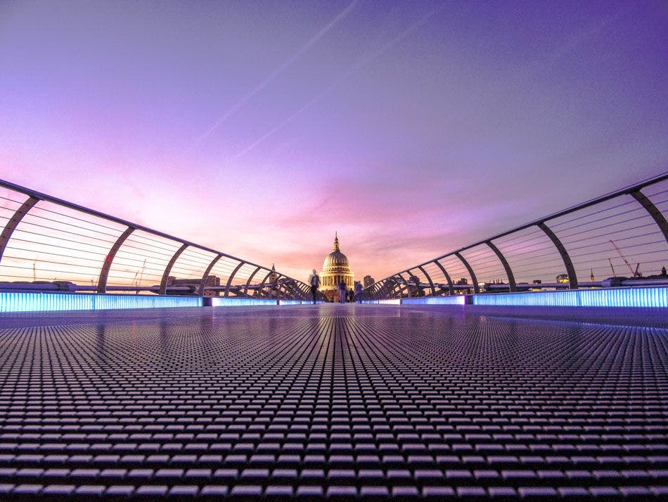 Image of St Paul’s Cathedral in the distance over a bridge.