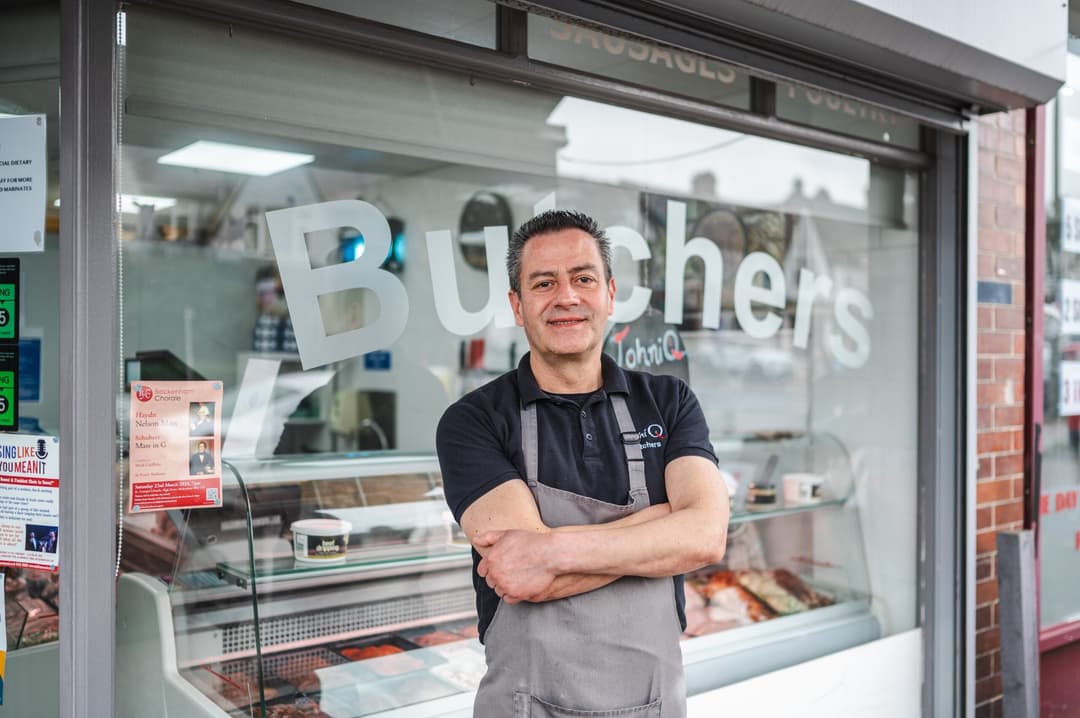 Image of a London underground sign in front of a building.