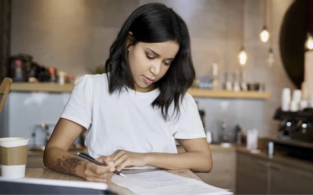 Image of a man working on his fruit stall, smiling at the camera.